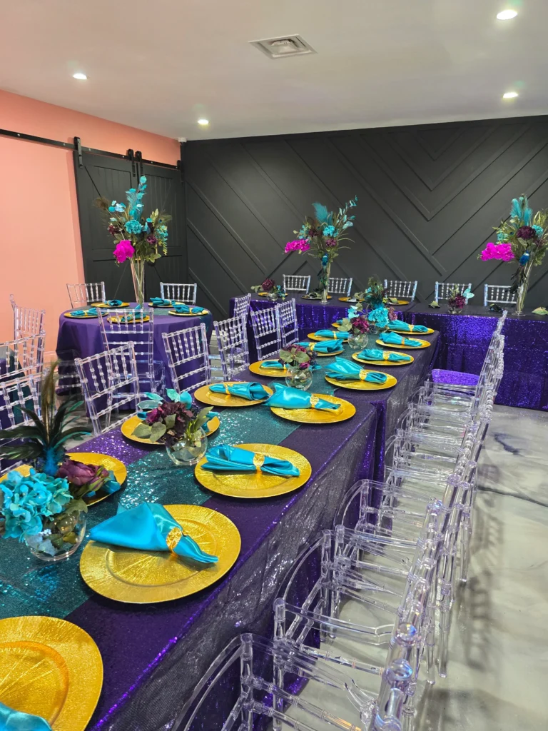 Elegant table setting with turquoise plates and gold accents in a modern dining space.
