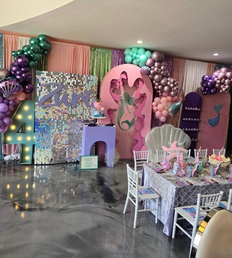 Elegant 18th birthday party setup with pink and purple decorations.