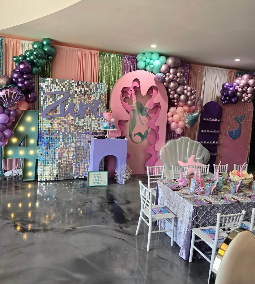 Elegant 18th birthday party setup with pink and purple decorations.